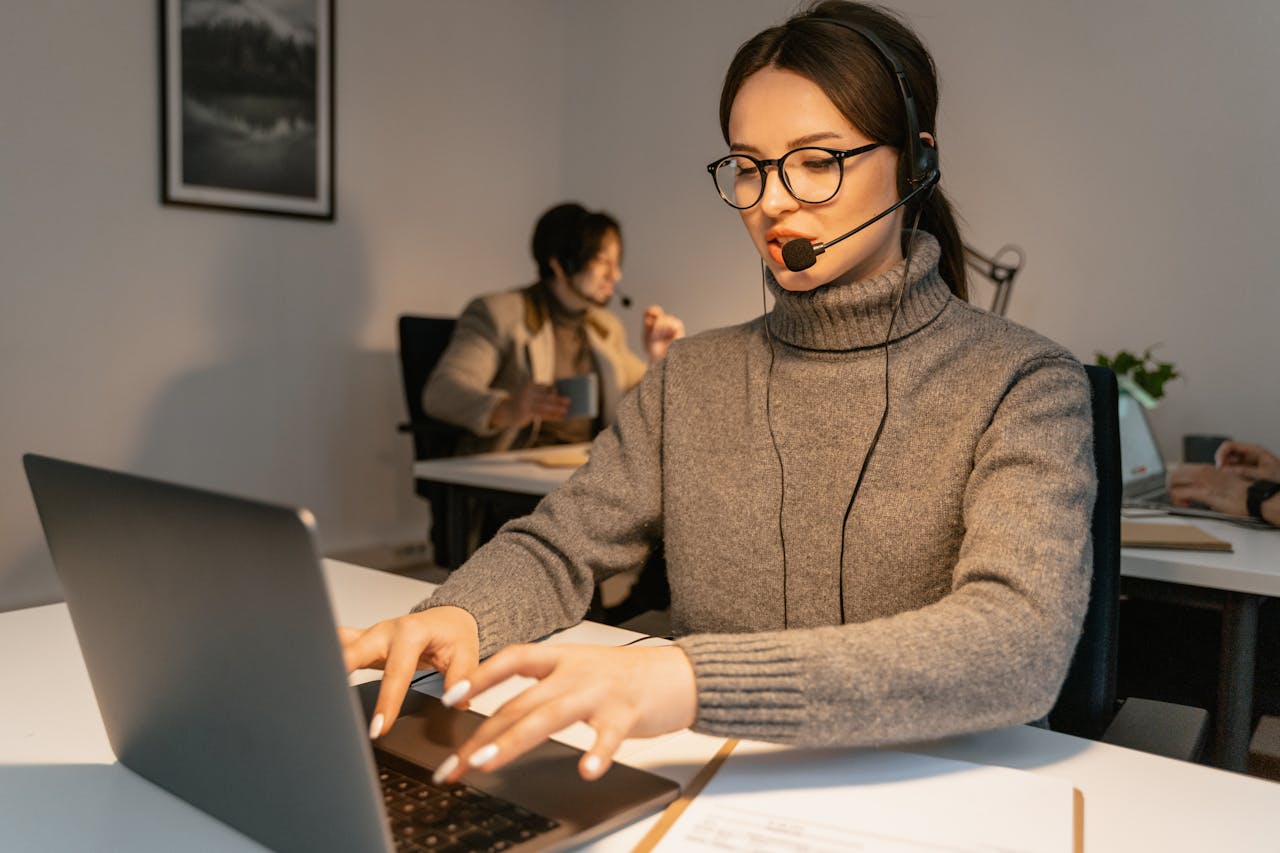 Home Two call center agents providing customer service in a modern office environment.