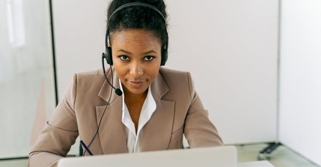 pexels photo 5467591 5467591 Confident woman in a call center setting, wearing a headset and suit, ready to assist.